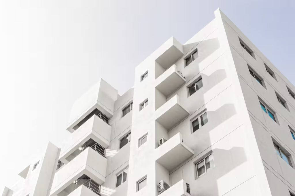 low-angle-shot-facade-white-modern-building-blue-clear-sky